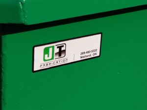 photo of JT Fabrication word mark on new made in Canada self dump hopper for waste and recycling